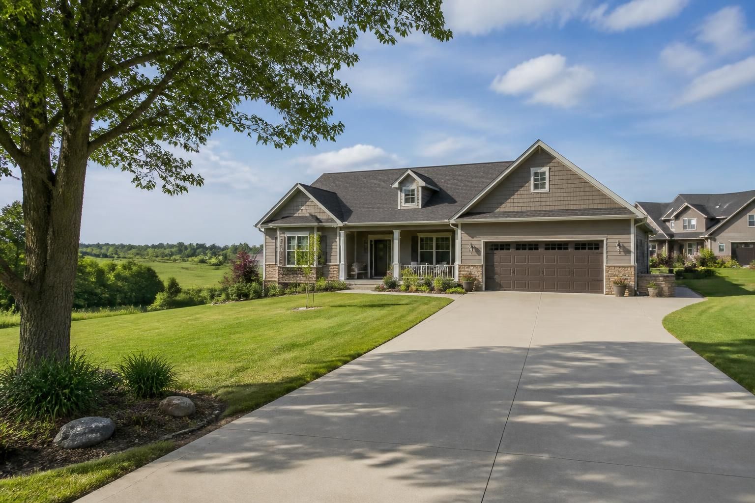 Rural-edge neighborhood with a finished concrete driveway.